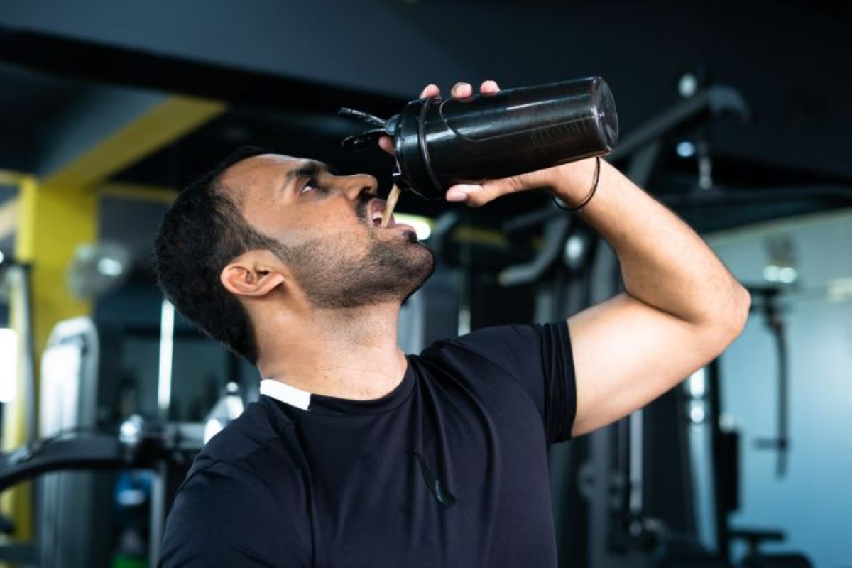 best-protein-powder-south-africa-bodybuilder-drinking-or-taking-protein-powder-and-mixing-with-water-on-bottle-by-shaking-at-gym-concpet-of-muscular-min