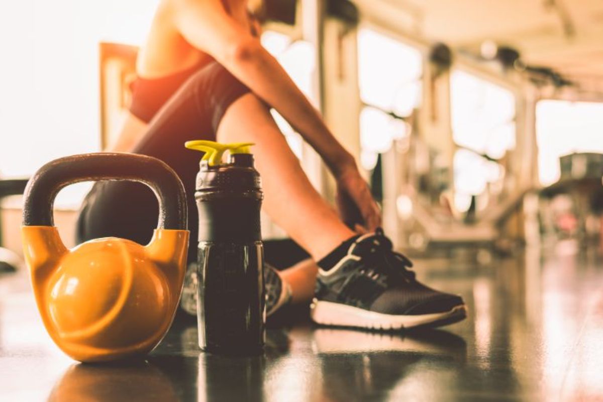 npl-supplements-close-up-kettlebells-with-woman-exercise-workout-in-gym-fitness-breaking-relax-after-training (1)-min